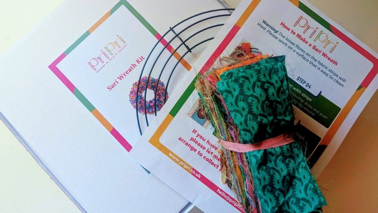 A wreath making kit for a Christmas wreath using off cuts from colourful saris